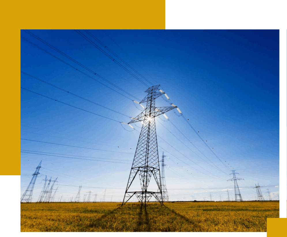 A field with power lines and a yellow sky