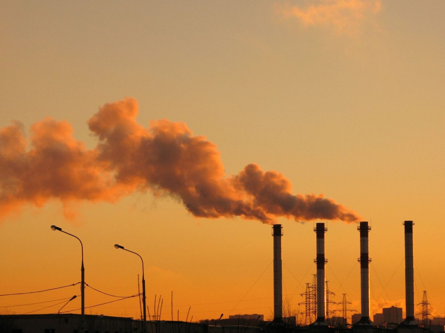 A factory with smoke coming out of the stacks.